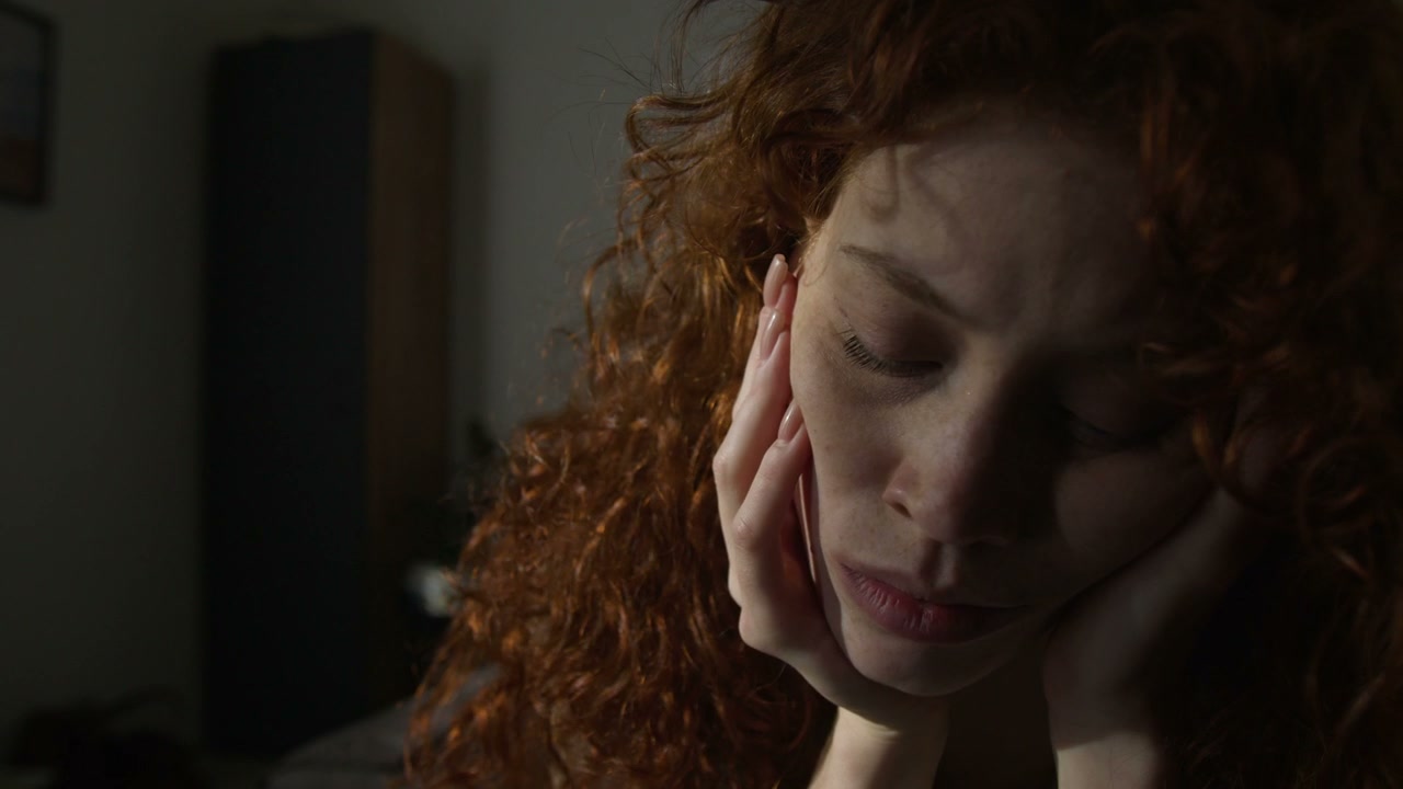 Close-Up of Sad Woman with Red Curly Hair