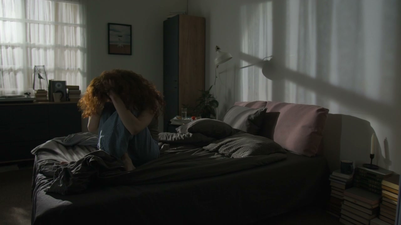 Woman in Emotional Distress on Bed