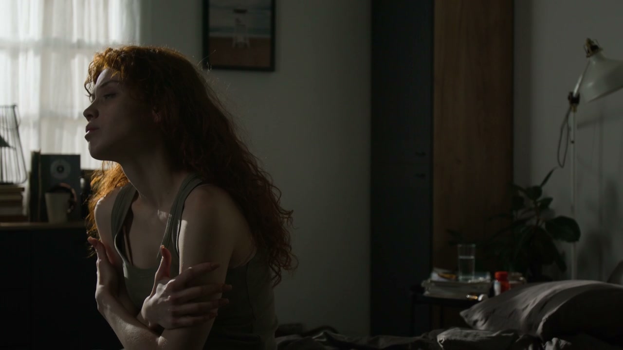 Distressed Woman Crying in a Dark Bedroom