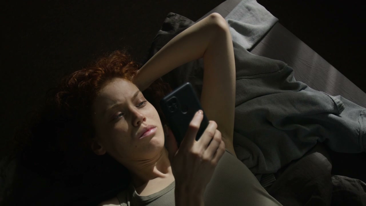 Lonely Woman Using Smartphone in Bed
