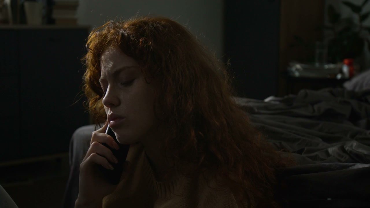 Distraught Woman Crying in Dark Bedroom
