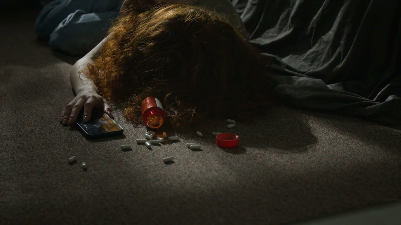 Woman Overdosed on Bedroom Floor with Pills