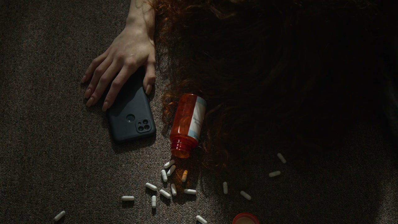 Woman Overdose on Floor with Pills