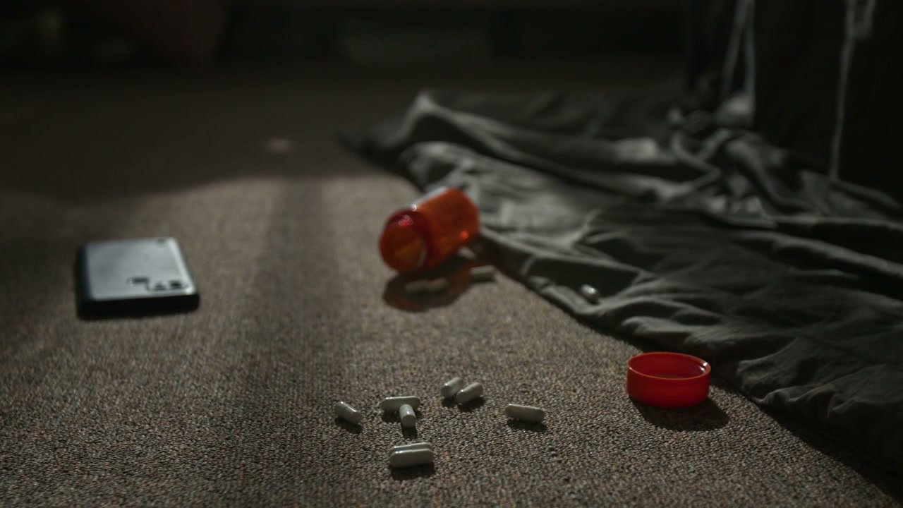 Hand Picking Up Pills From Floor