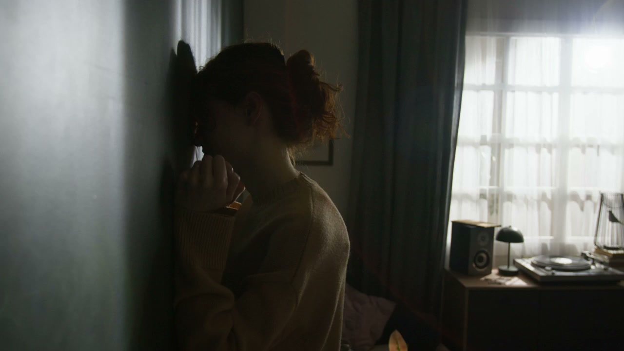 Distressed Woman in Dim Bedroom