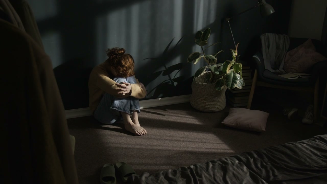 Sad Woman Crying Alone on Bedroom Floor