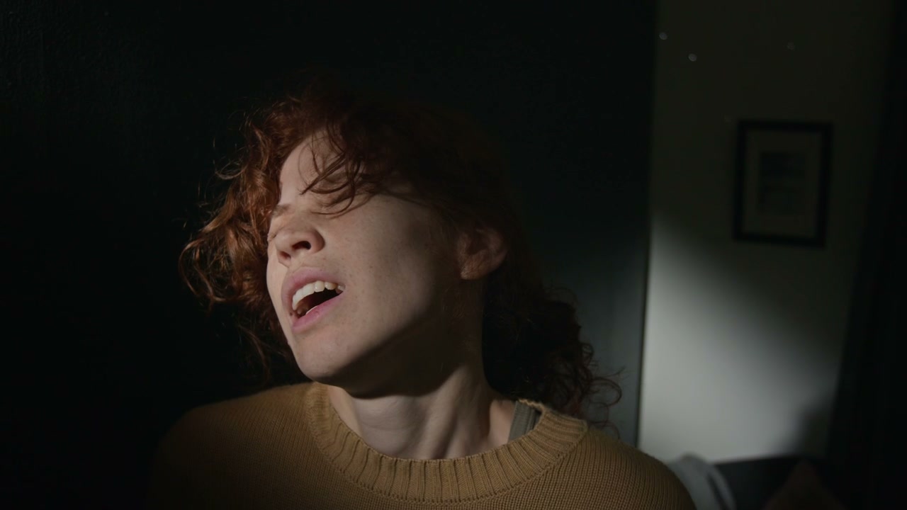 Distraught Woman Screaming in Dark Room