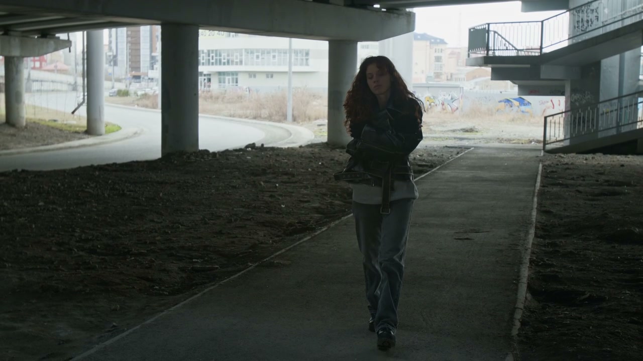 Sad Woman Walking Under Urban Underpass