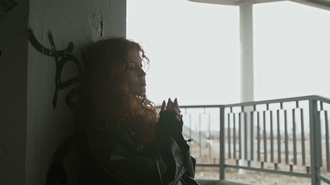 Pensive Woman Under Urban Bridge