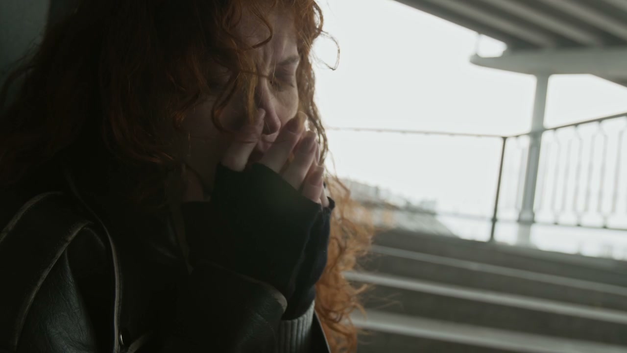 Distressed Woman Crying in Urban Underpass