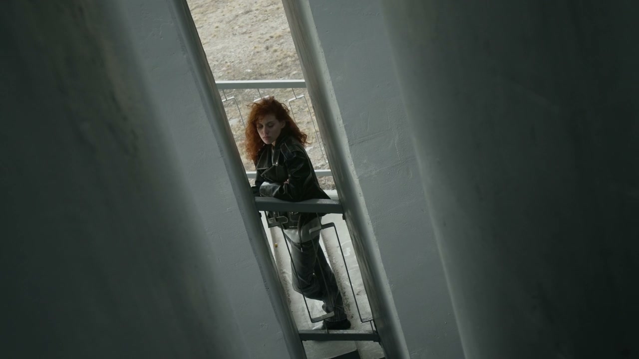 Pensive Woman Standing in Concrete Underpass