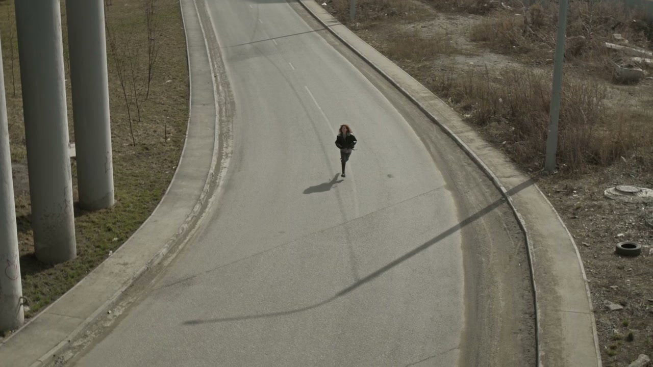 Lonely Person Runs Along Urban Overpass