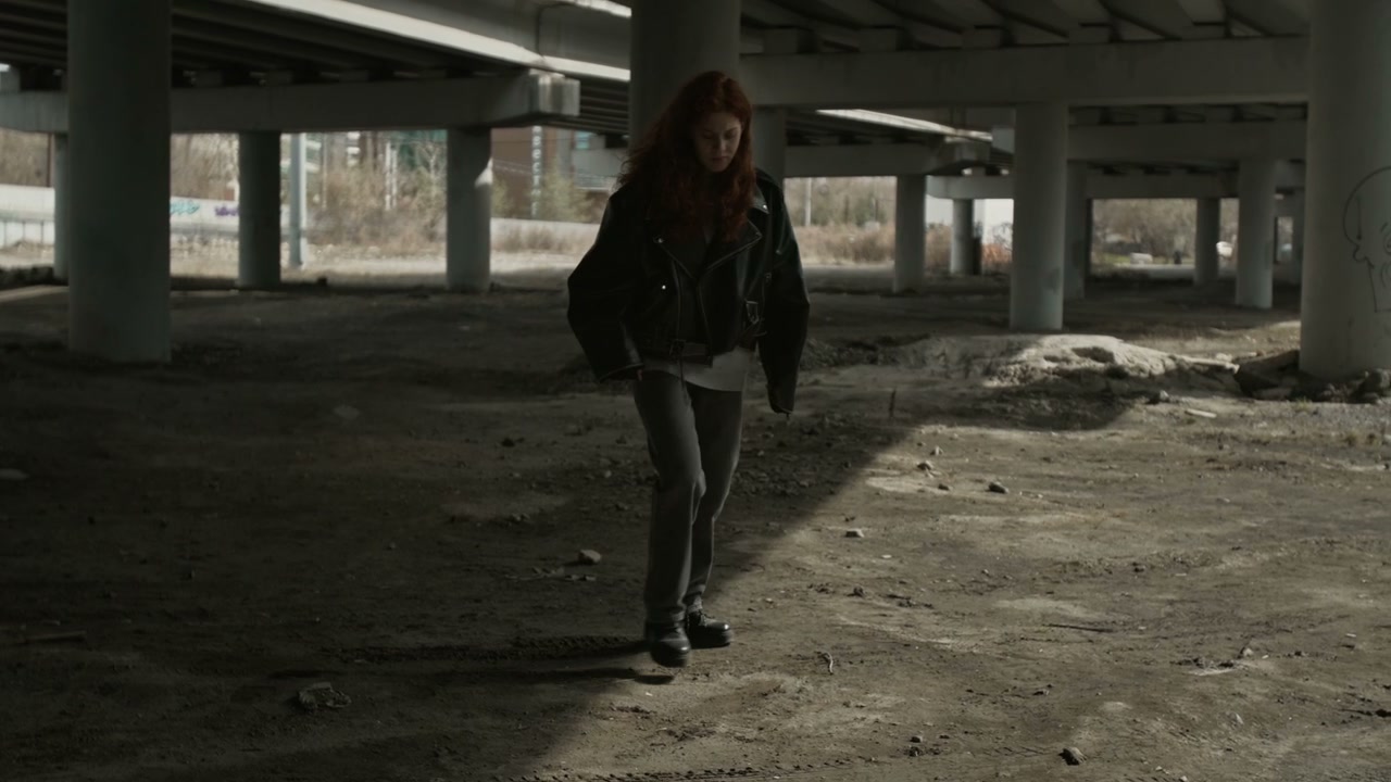 Sad Woman Crouches Under Urban Overpass