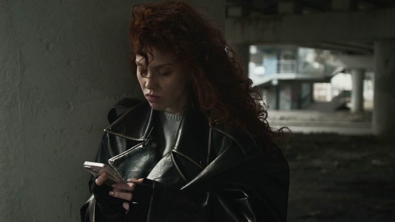 Distressed Woman in Underpass Using Smartphone