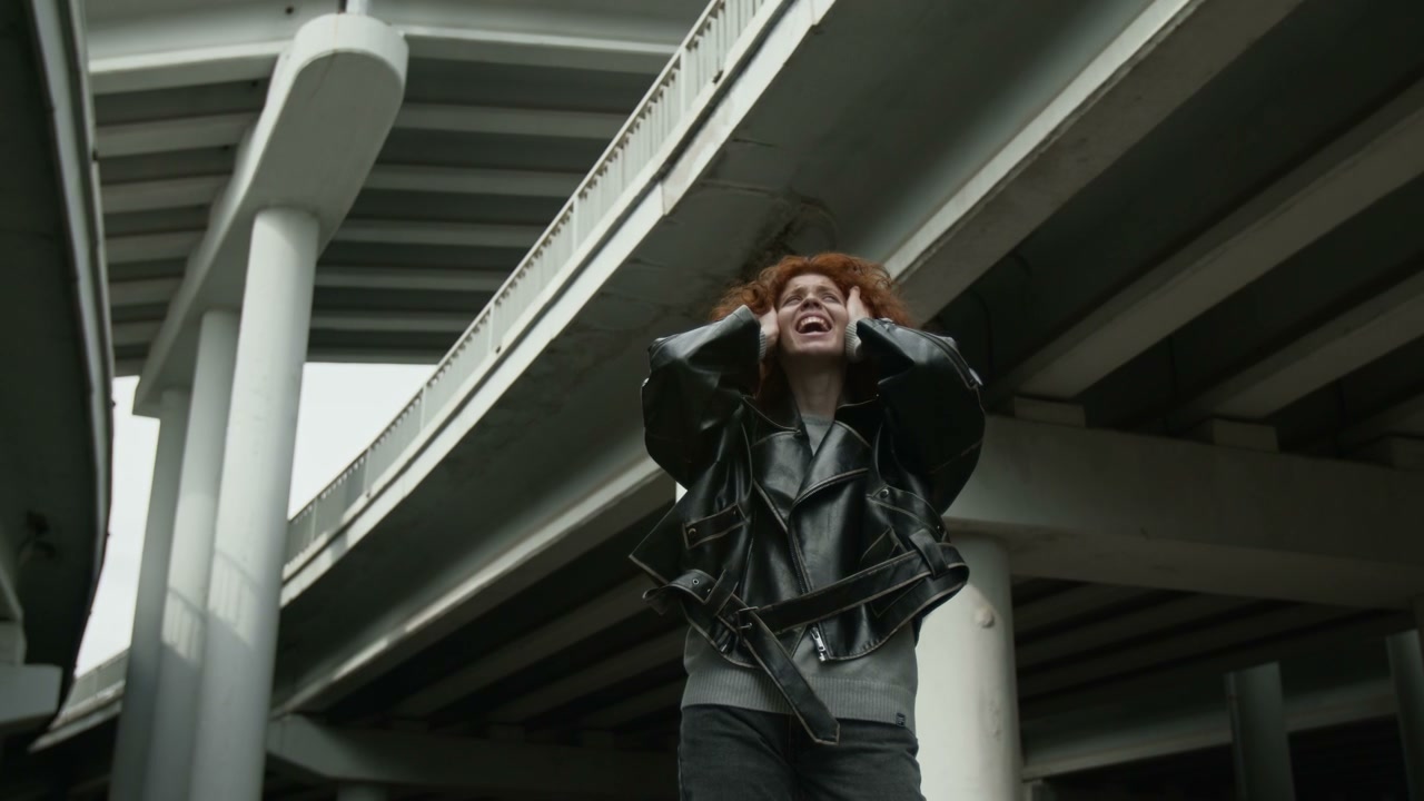 Woman in Anguish Under City Bridge