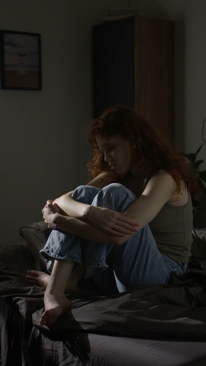 Depressed Young Woman Crying on Bed