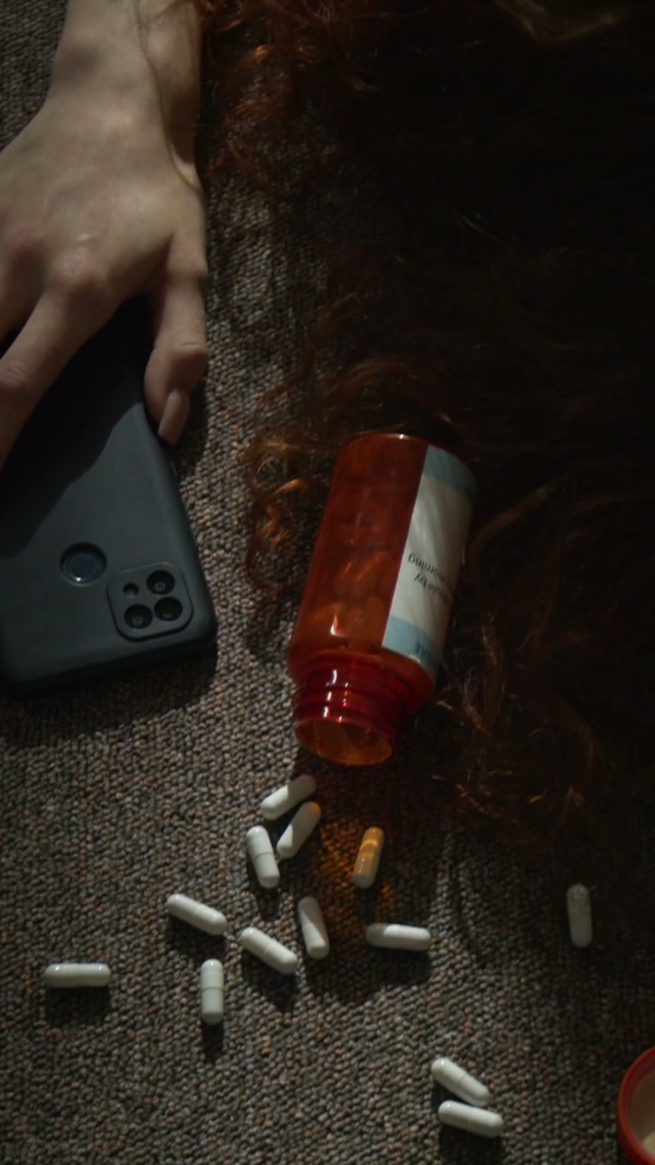 Unconscious Person on Floor with Spilled Pills