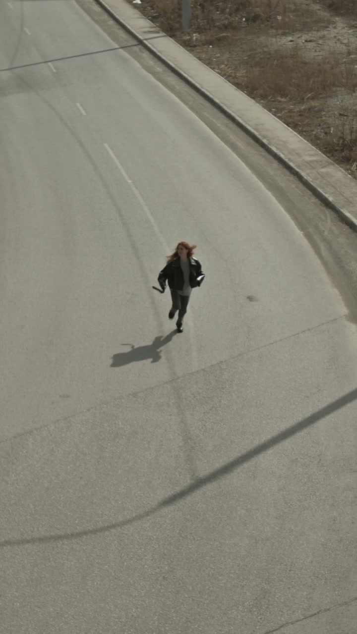 Woman Running on Deserted Urban Road
