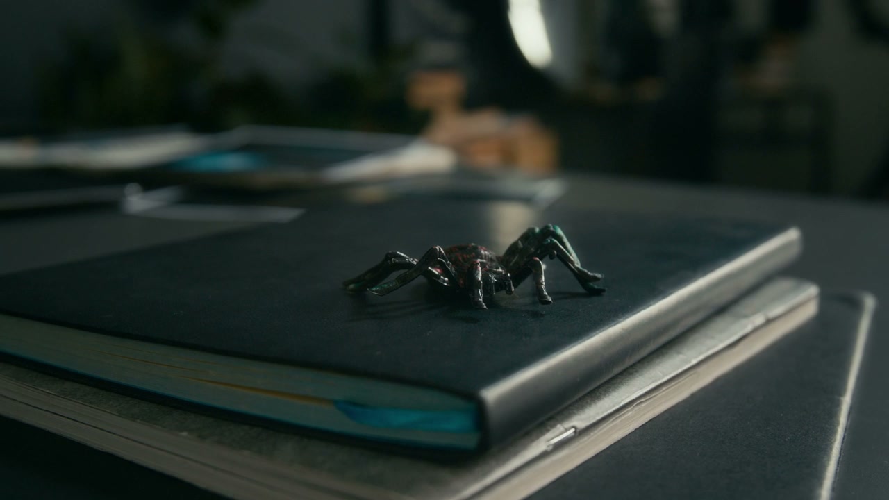 Gothic Spider Figurine on Black Notebook