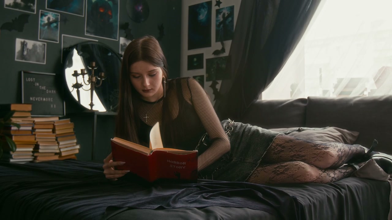 Goth Girl Reads Horror Story in Bedroom