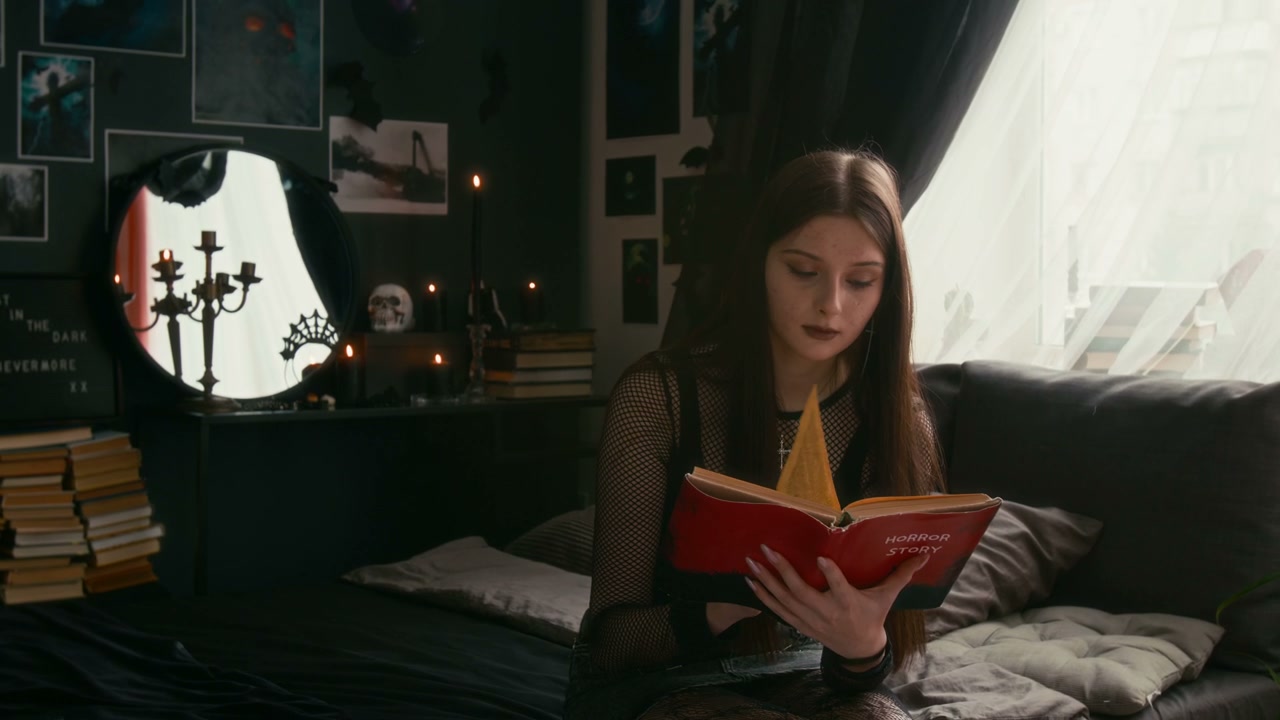 Goth Teenager Reading Book in Bedroom
