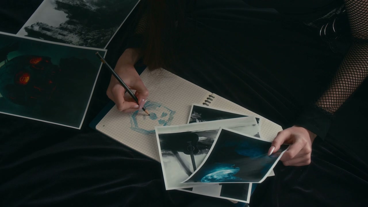 High Angle View of Gothic Person Sketching Skull