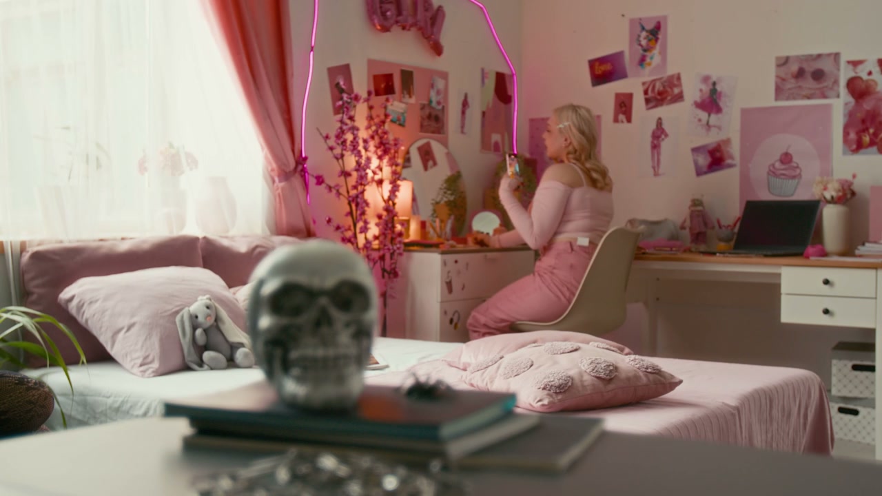 Young Woman Applying Makeup in Pink Goth Room