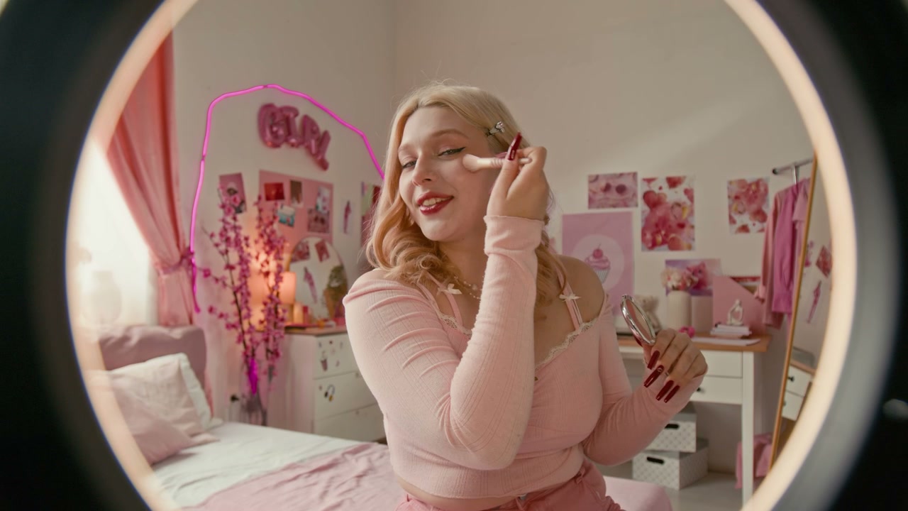 Gen Z Influencer Applies Makeup in Pink Room