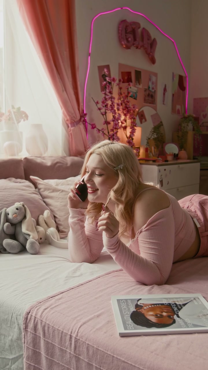 Gen Z Girl Talking on Phone in Pink Bedroom