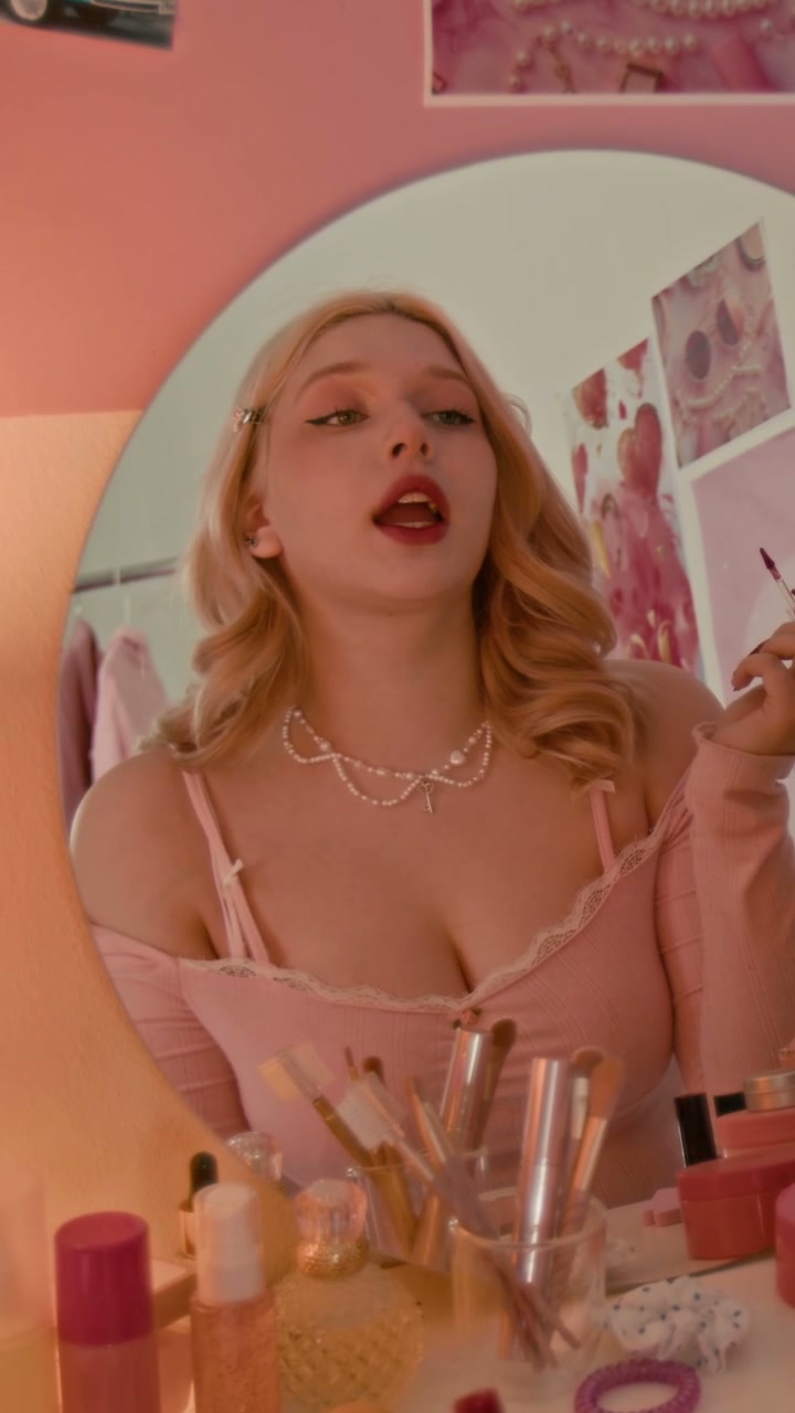 Young Woman Applying Lipstick at Vanity