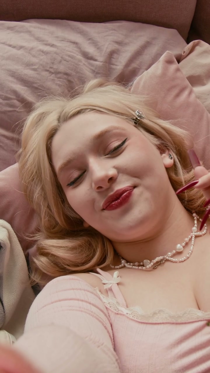 Gen Z Creator Posing for Camera on Pink Bed