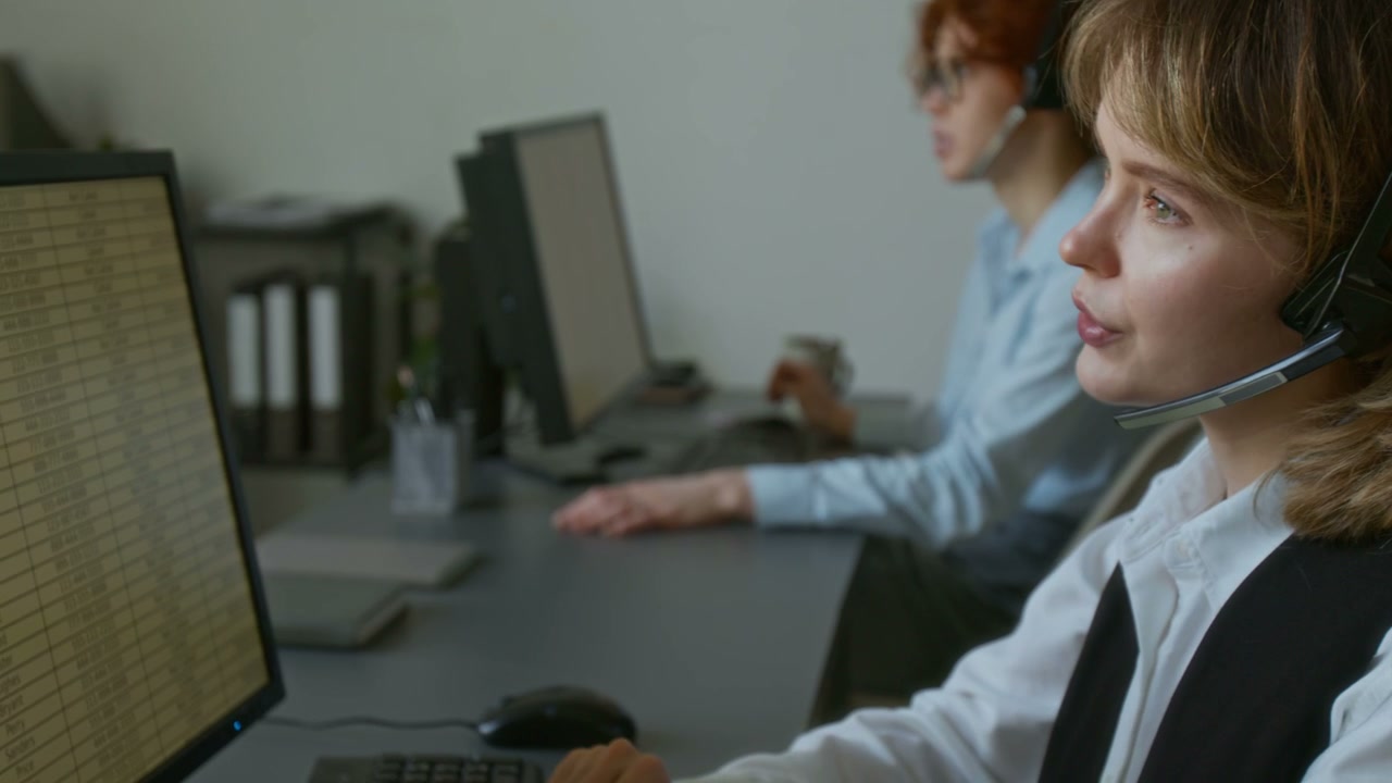 Call Center Agent Talking on Headset at Desk