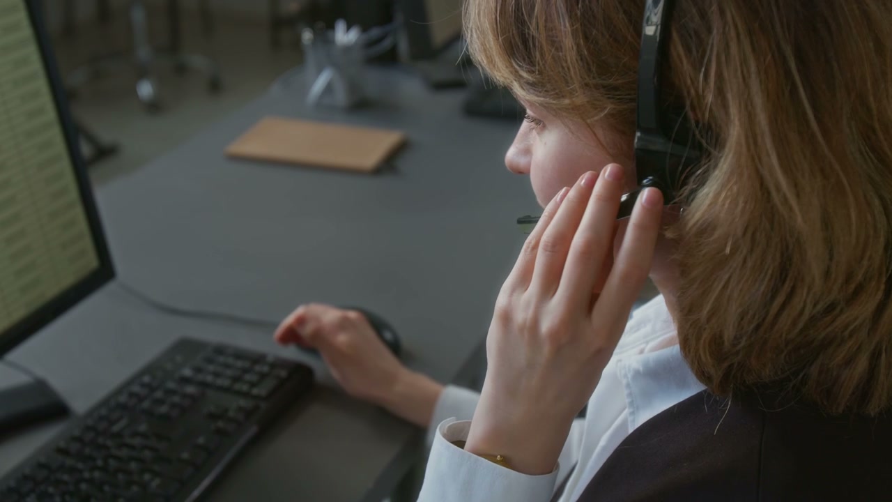Call Center Agent Working at Computer