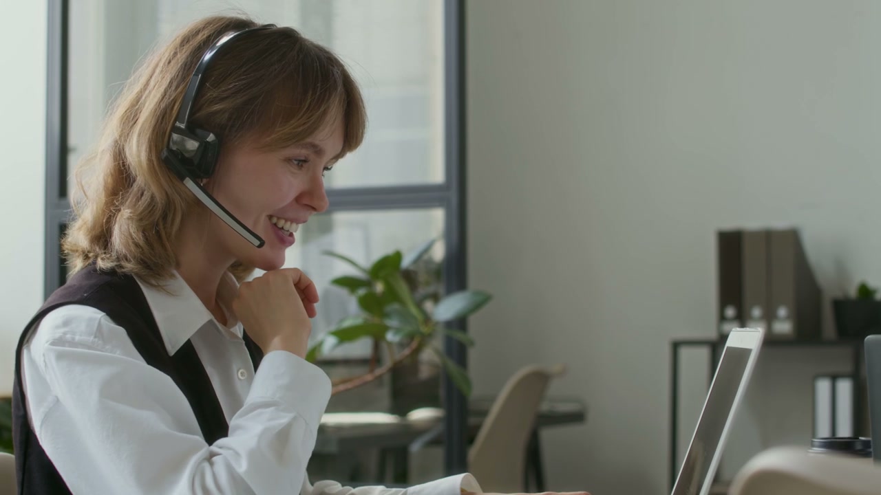 Smiling Call Center Agent Talking on Headset