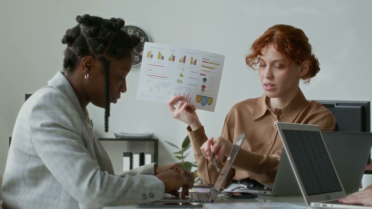 Businesswomen Reviewing Financial Report