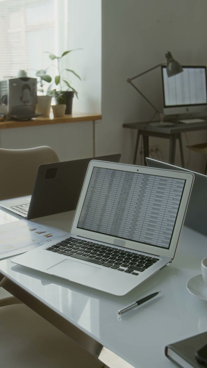 Empty Office Desk with Laptop Displaying Data