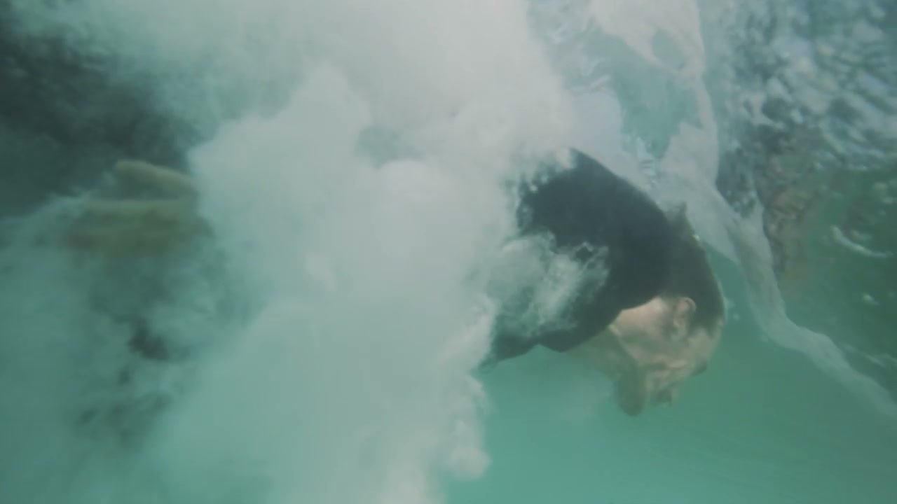 Slow Motion Bodysurfer Diving Underwater