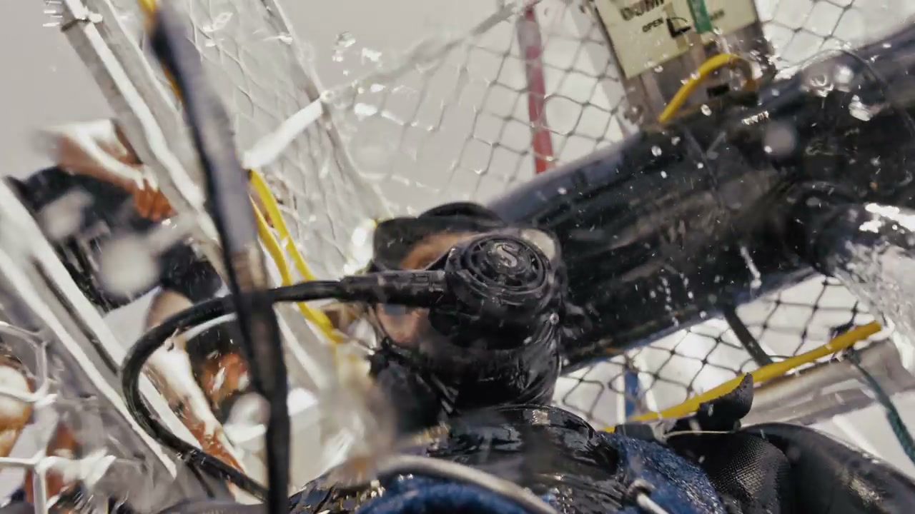 Diver Entering Water in Dive Cage