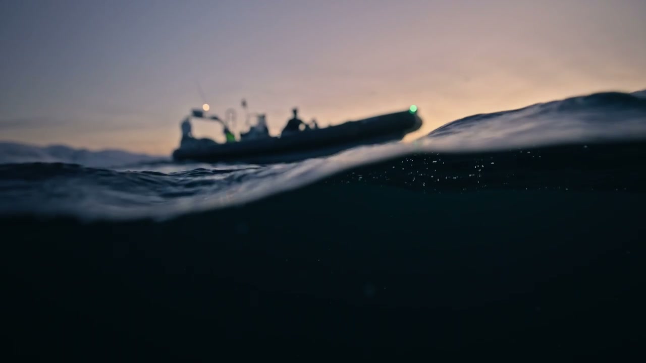 Half Underwater View of Boat at Arctic Sunset