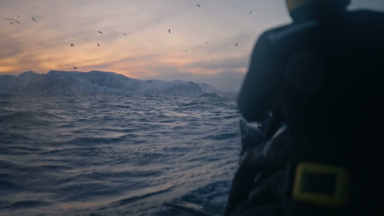 Diver on Boat in Arctic Sea at Sunset