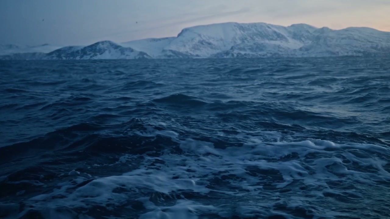 Rough Arctic Sea with Snow-Capped Mountains