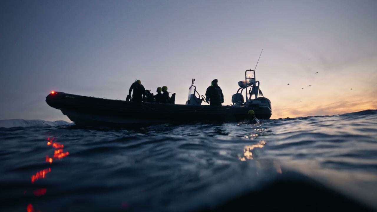 RIB Boat with People on Arctic Water at Dusk