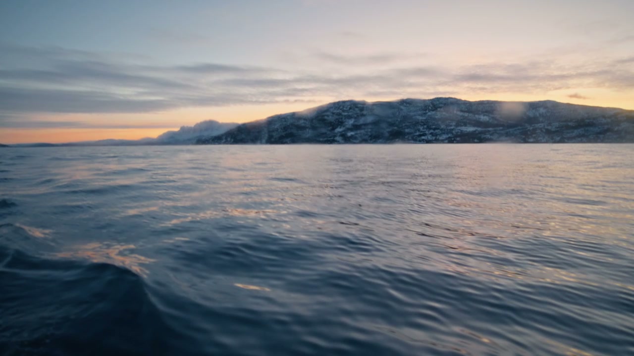 Norwegian Arctic Sea with Snowy Mountains at Sunset