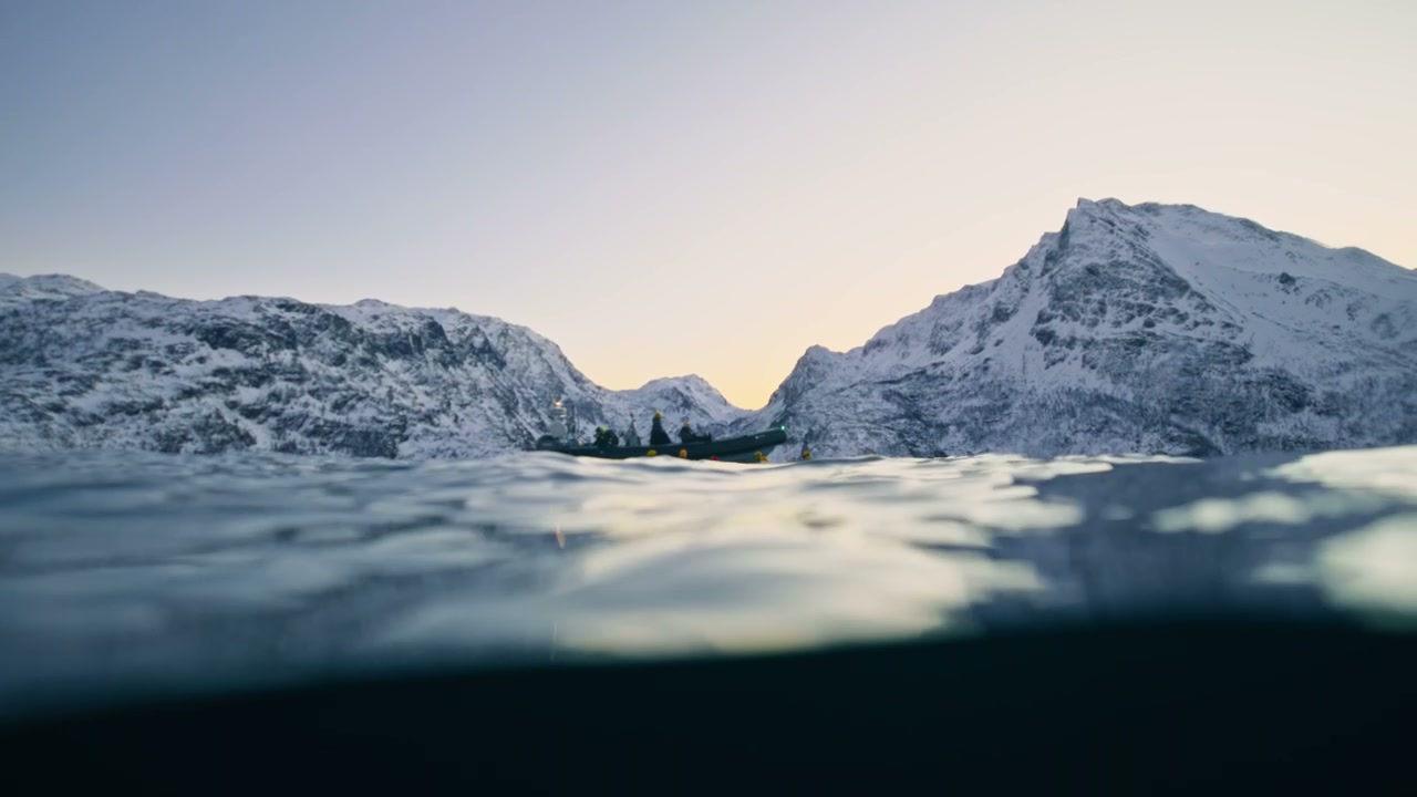 Boat Navigating Snowy Fjord in Norway