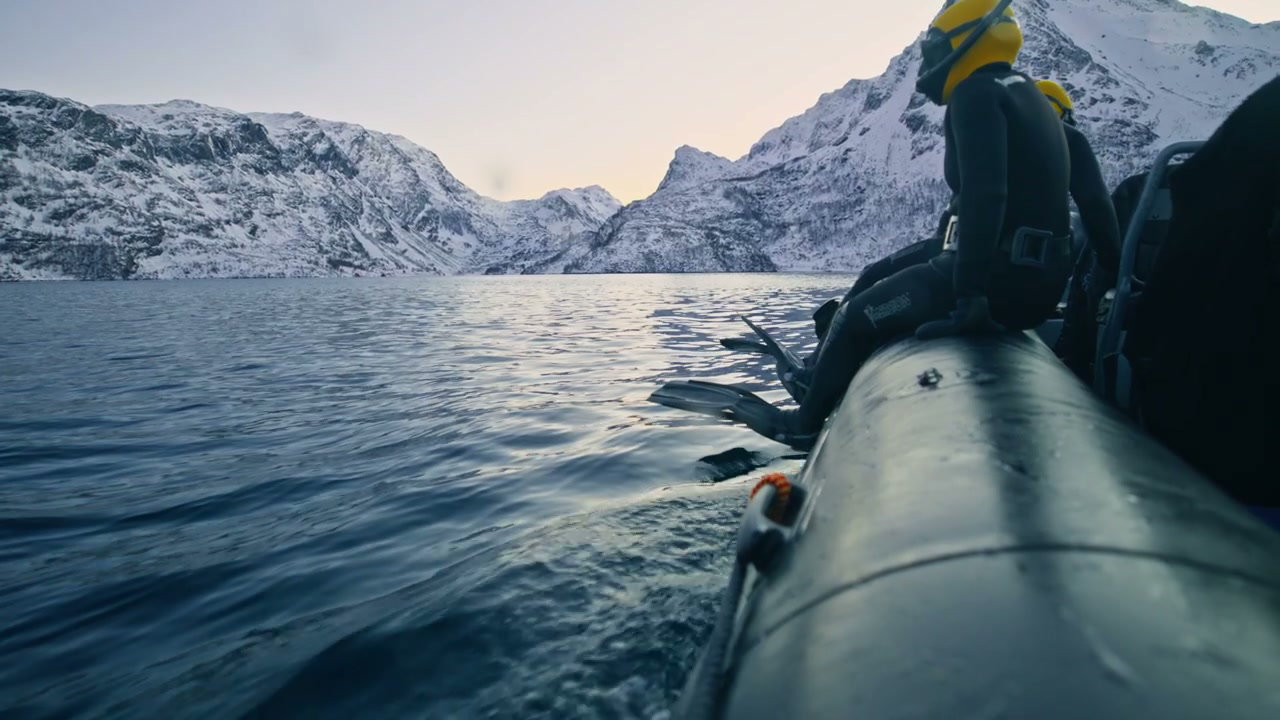 People in Wetsuits on Boat in Norway Fjord