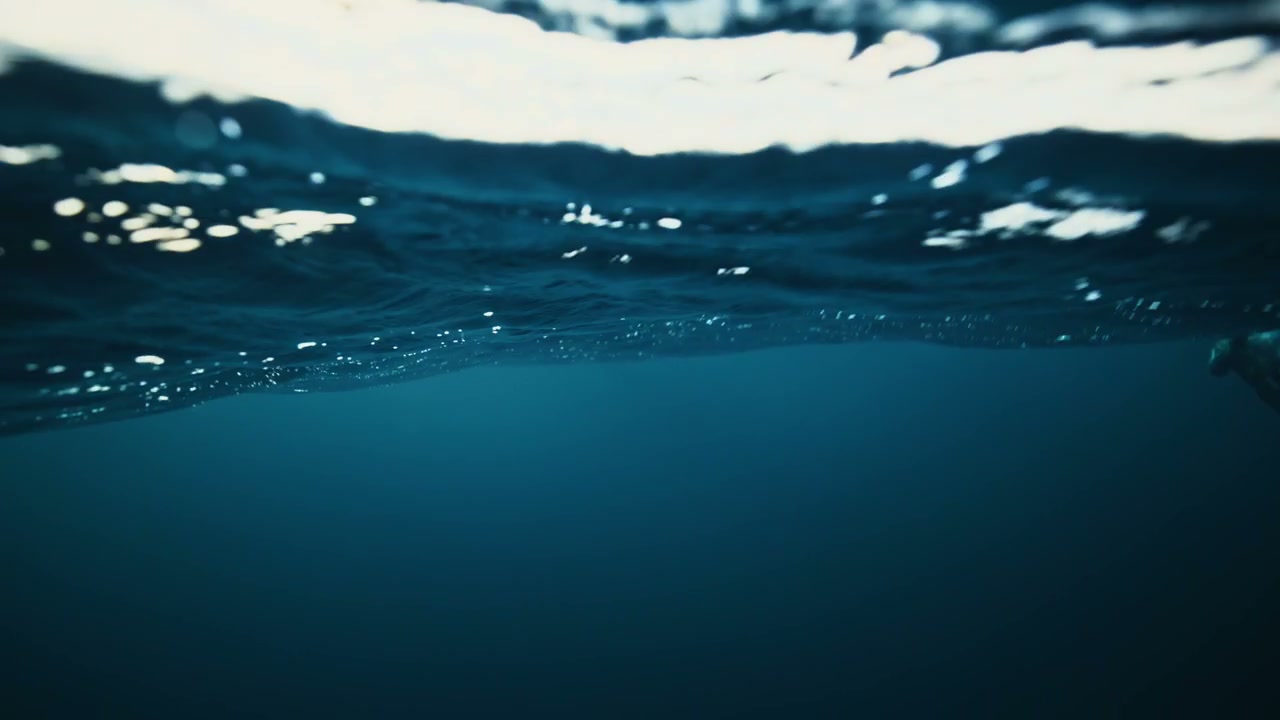 Underwater View of Shimmering Water Surface