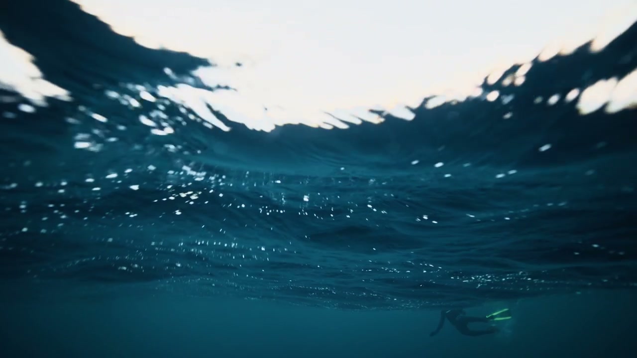 Free Diver Swimming in Arctic Ocean
