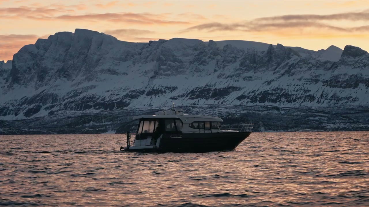 Boat Floating in Arctic Fjord at Sunset