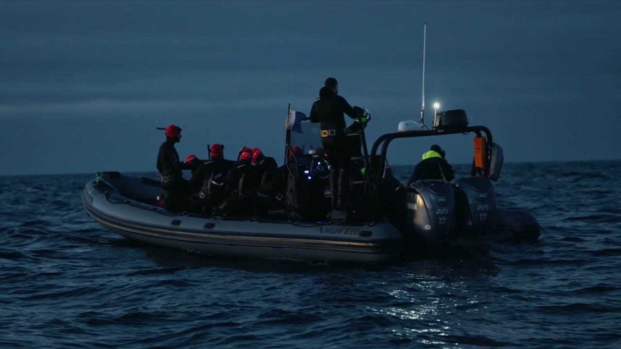 Rib Boat with People in Arctic Water at Dusk