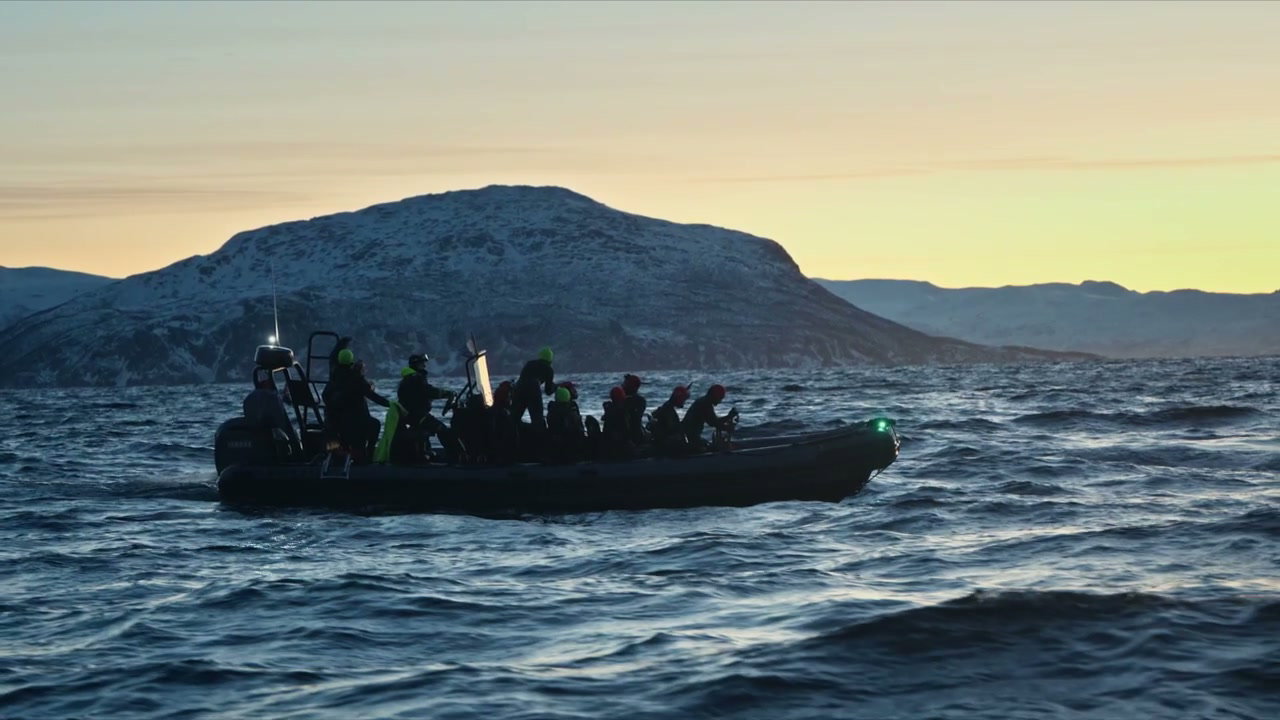 RIB Boat Cruising Arctic Fjord at Sunset